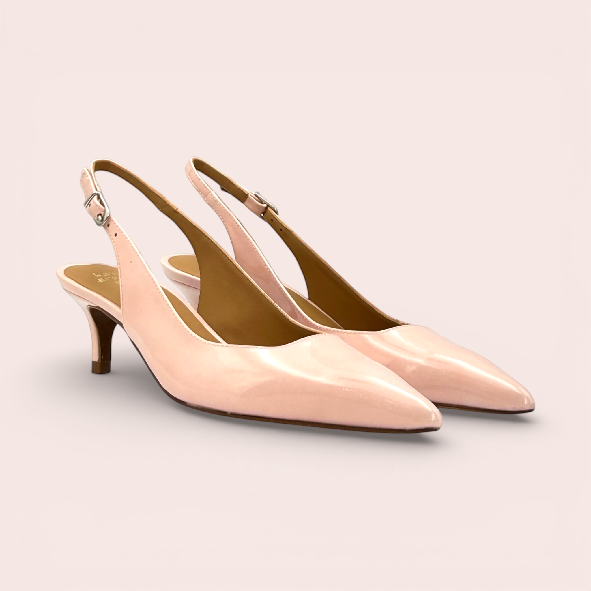 Pale pink patent leather slingback heels with a pointed toe, kitten heel, and adjustable ankle strap. Made in Spain.