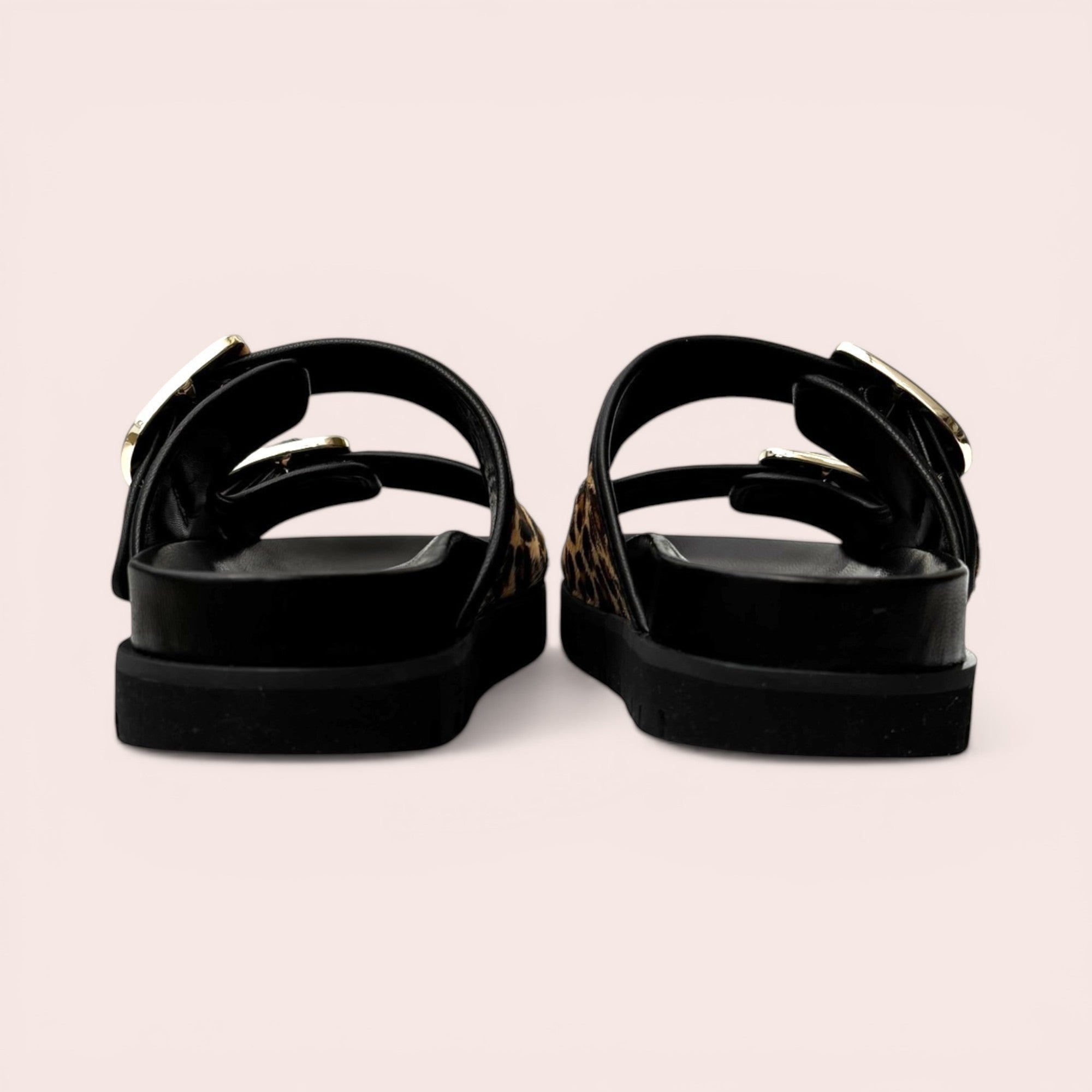 Black platform sandals with leopard print straps and gold-tone buckles, featuring a chunky sole.