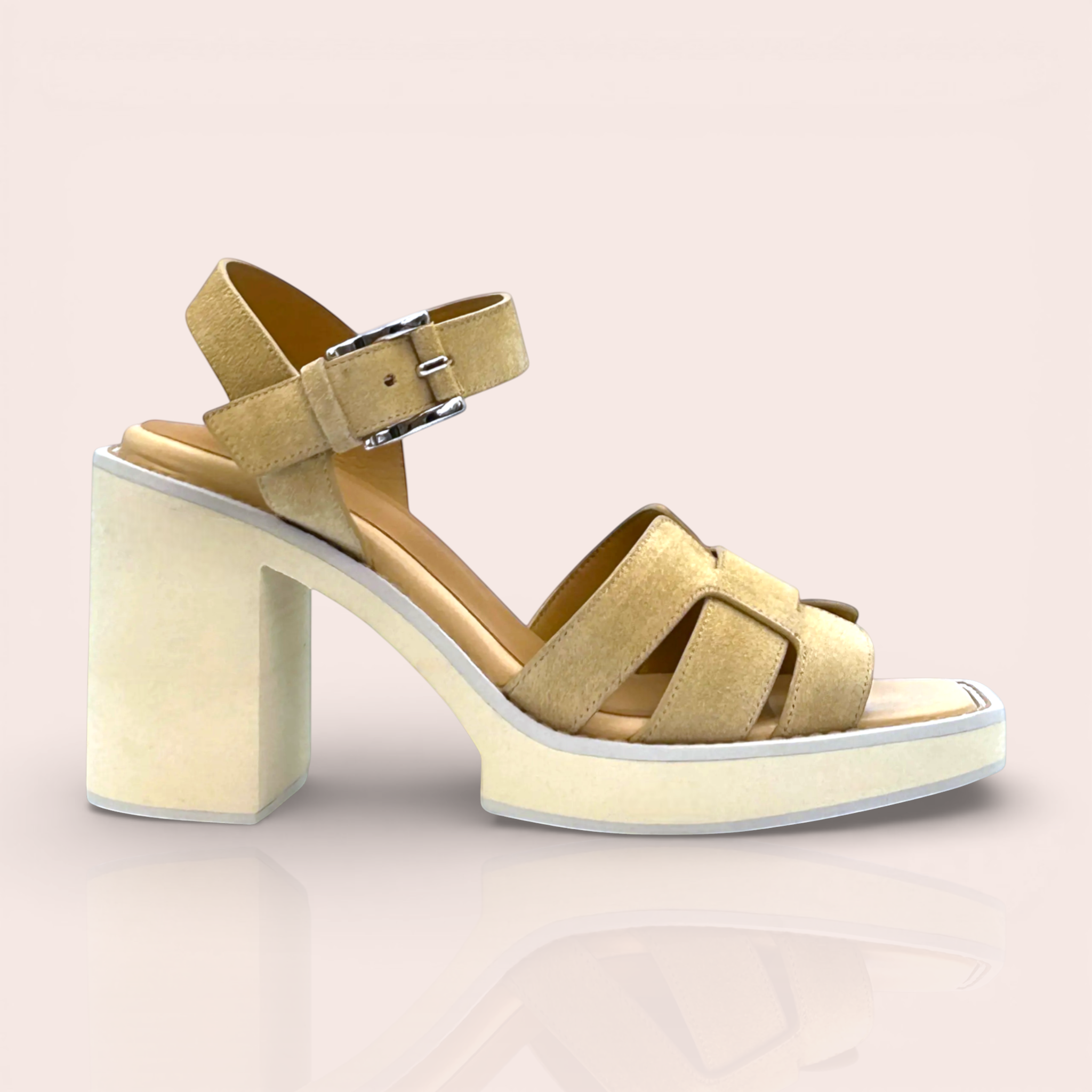 Tan suede platform sandals with criss-cross straps and an adjustable ankle strap with a silver buckle. Features a chunky block heel and a light beige sole.