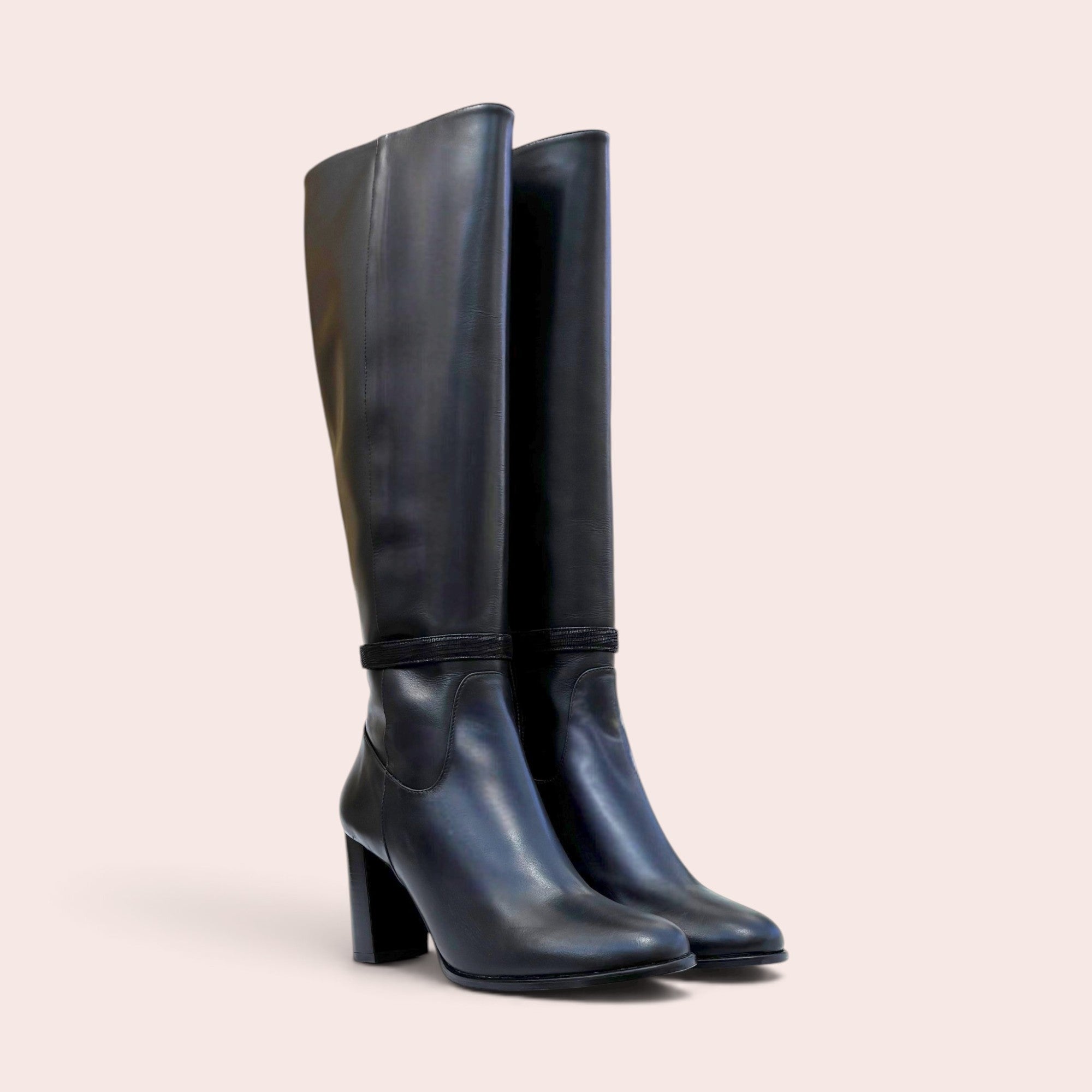Pair of smooth black leather knee-high boots with a sturdy block heel and a refined ankle strap detail.