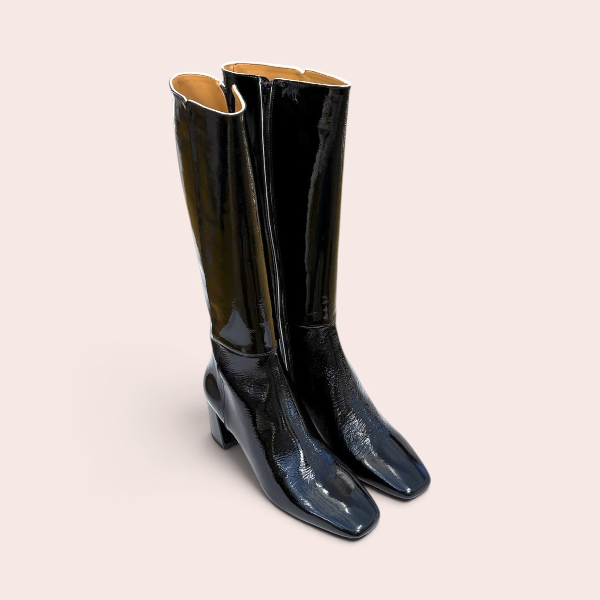 Black patent leather knee-high boots with a square toe and sturdy block heel, featuring a side zip closure.