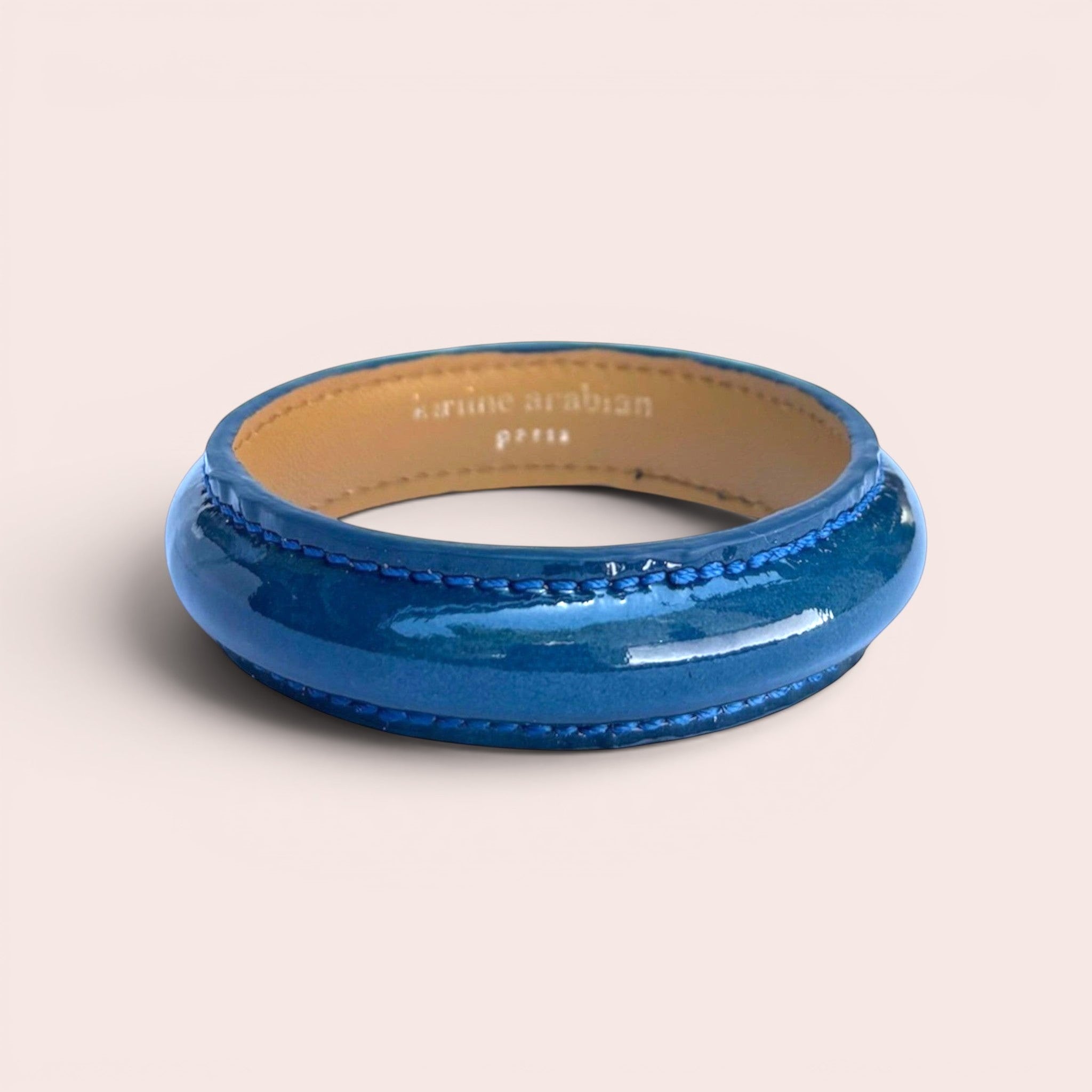 Duck blue patent leather bangle bracelet with visible stitching and tan interior lining by Karine Arabian
