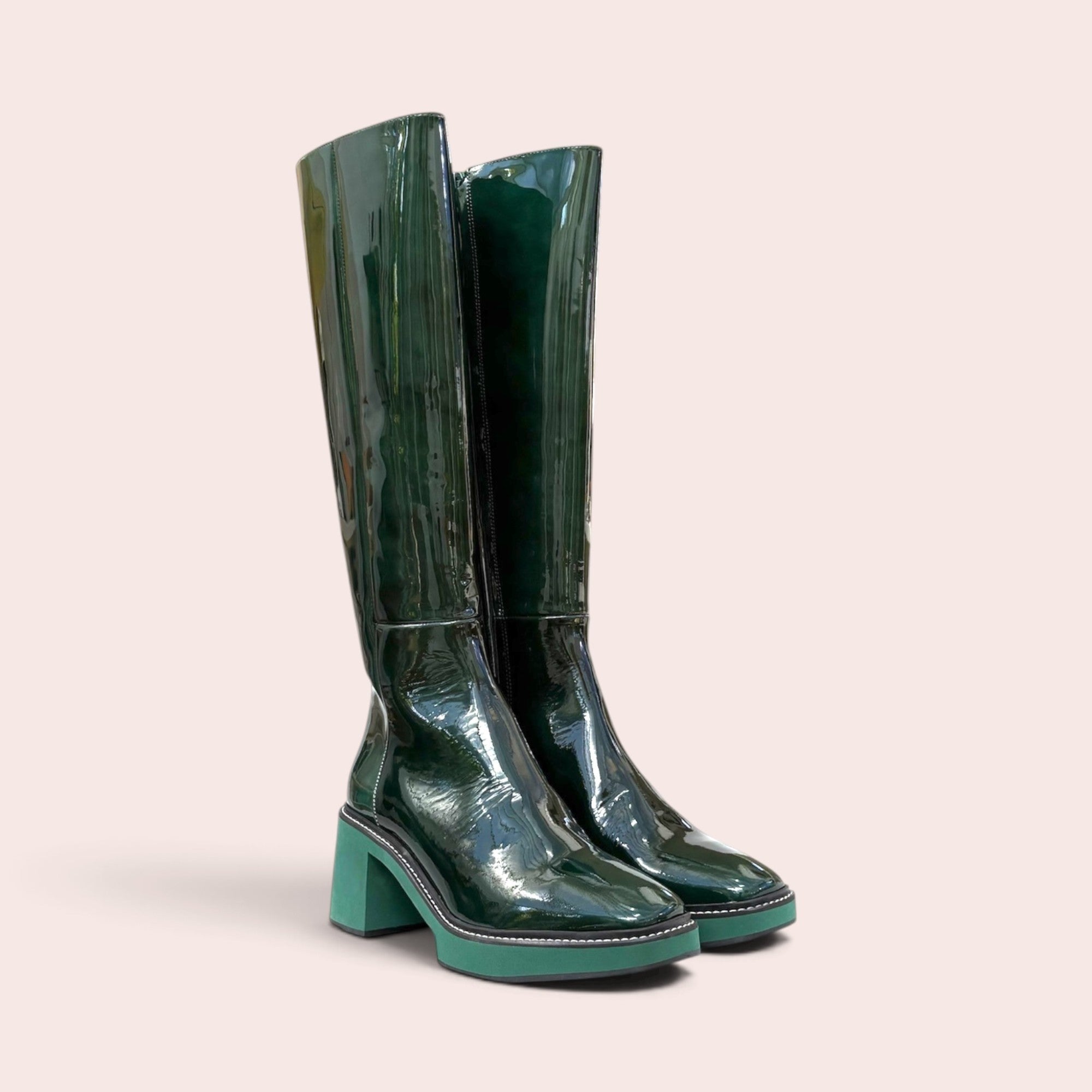 Forest green patent leather knee-high boots with a square toe, block heel, and contrasting light green platform sole.