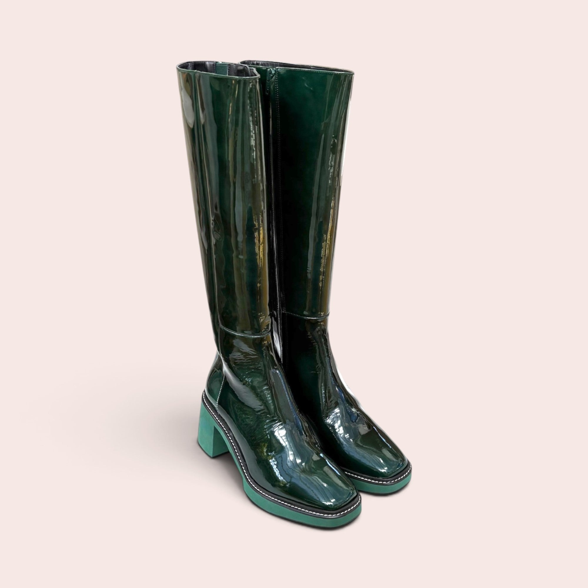 Forest green patent leather knee-high boots with a square toe, contrasting light green block heel, and platform sole.