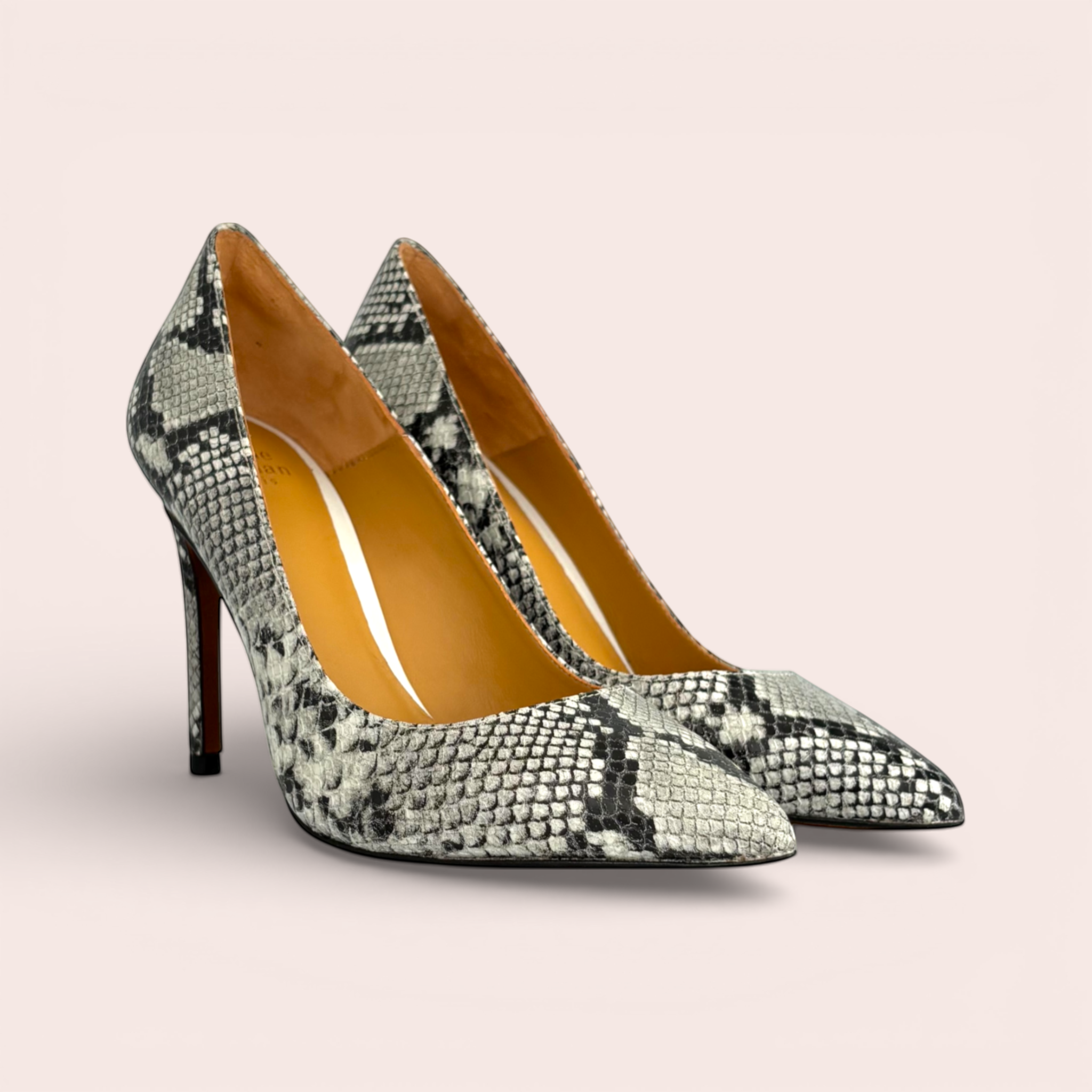Black and white snakeskin print leather stiletto heels with pointed toes.
