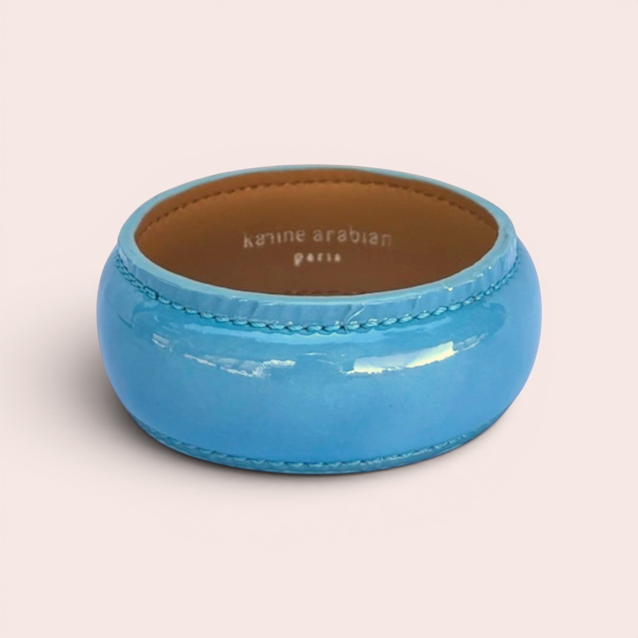 Karine Arabian DUA wide bangle bracelet in glossy Maya blue patent leather with a tan interior lining.