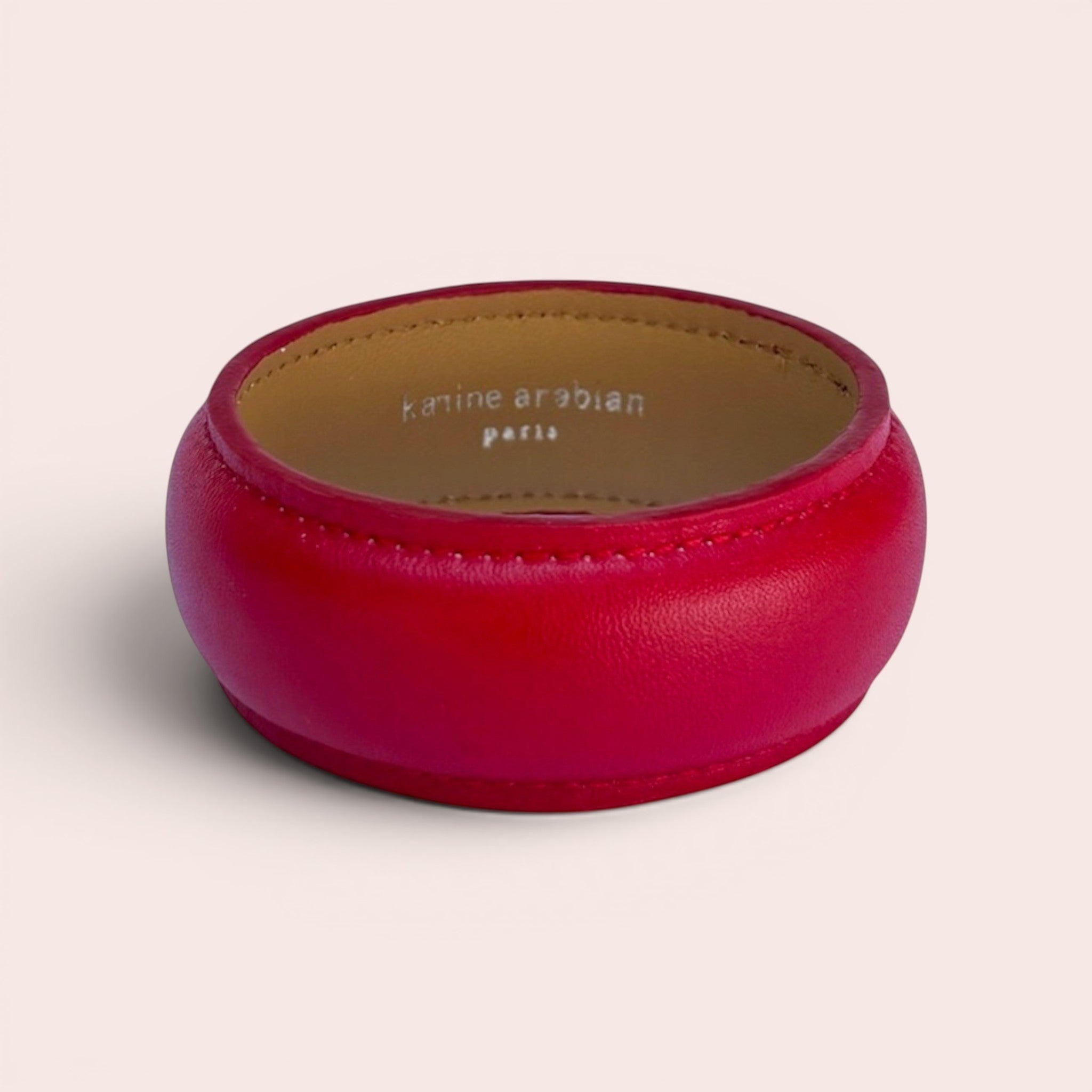 Karine Arabian DUA wide bangle bracelet in smooth red leather with a beige interior lining.