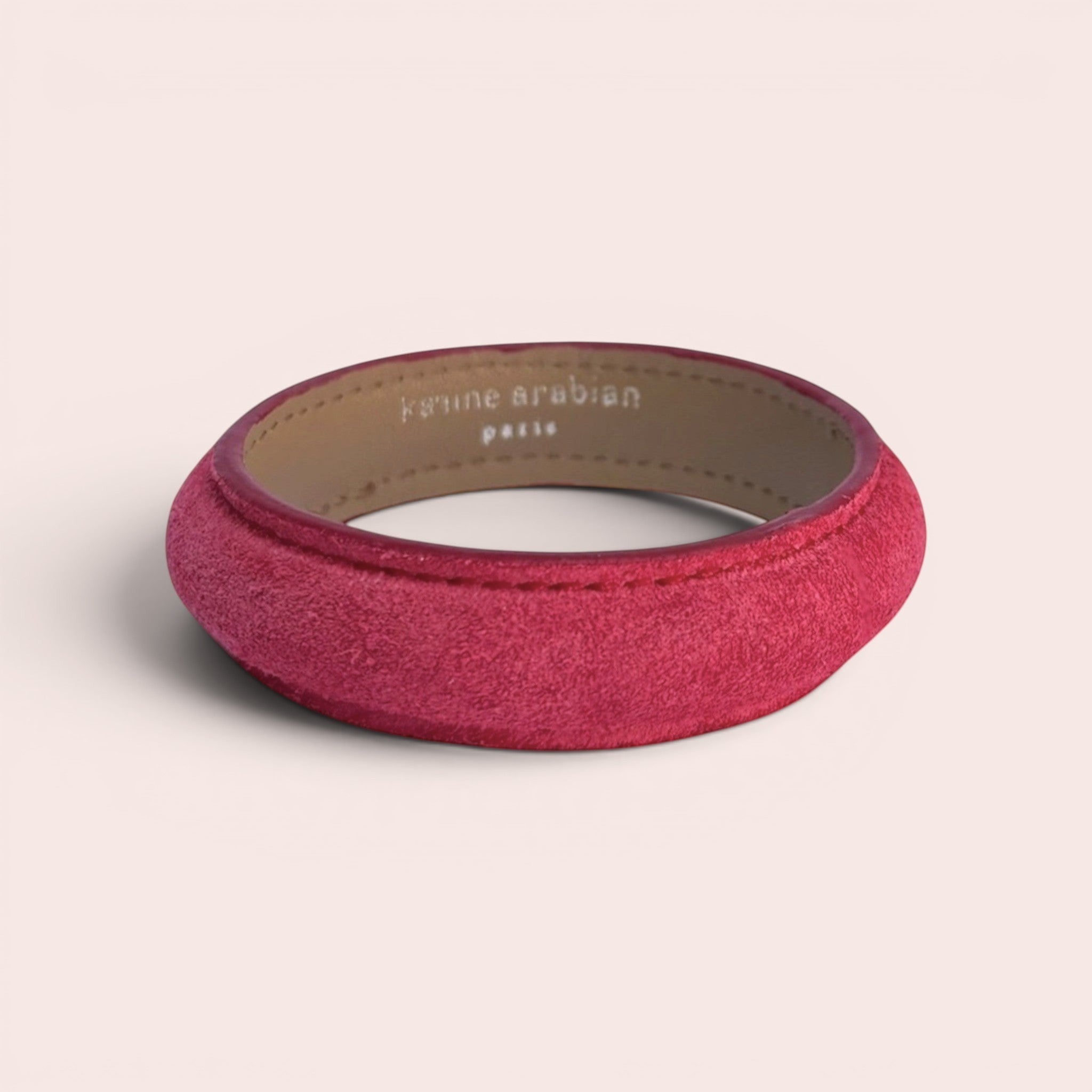Karine Arabian Jonc bracelet in vibrant red suede leather with a smooth interior lining and minimalist design.