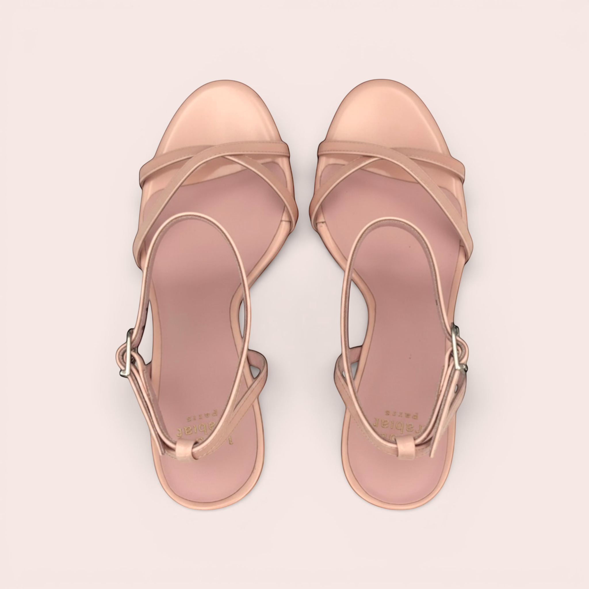 Pale pink patent leather Cindy sandals with clear straps and a silver buckle.