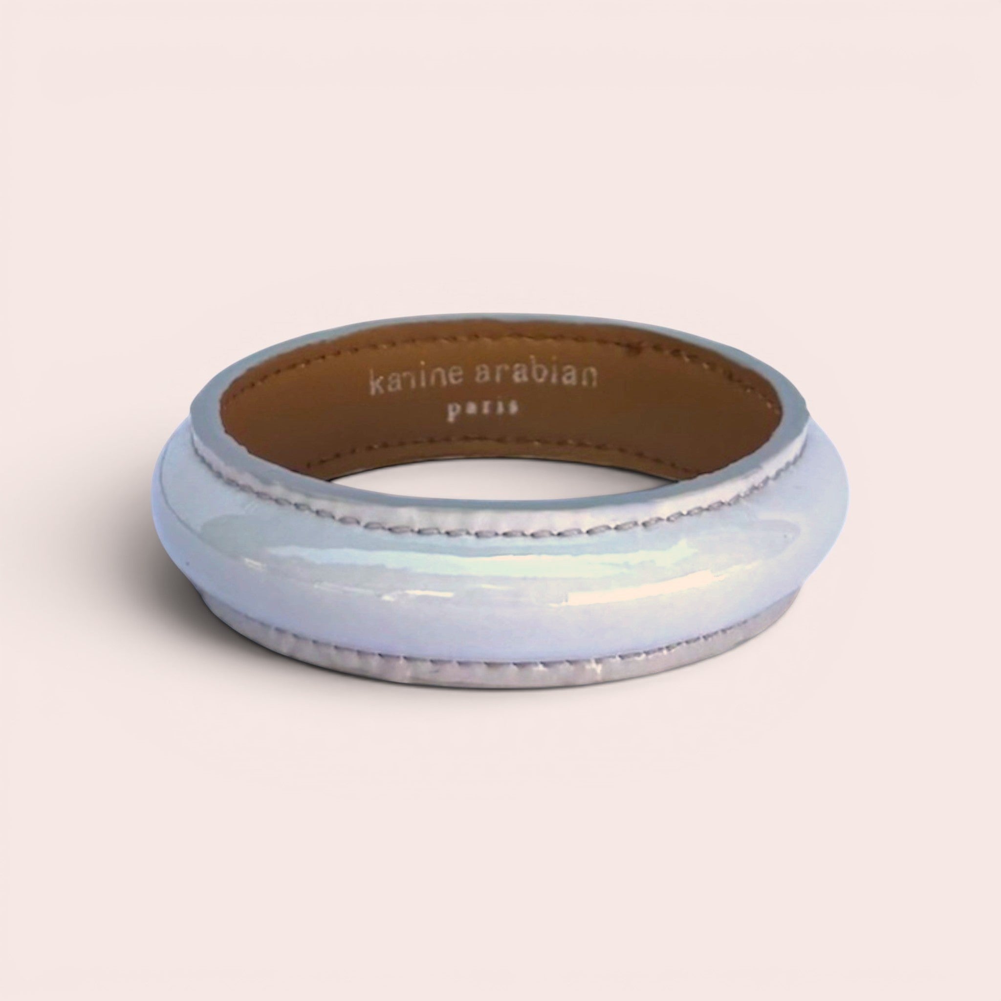 Karine Arabian pearl grey patent leather bangle bracelet with tan interior lining and visible stitching