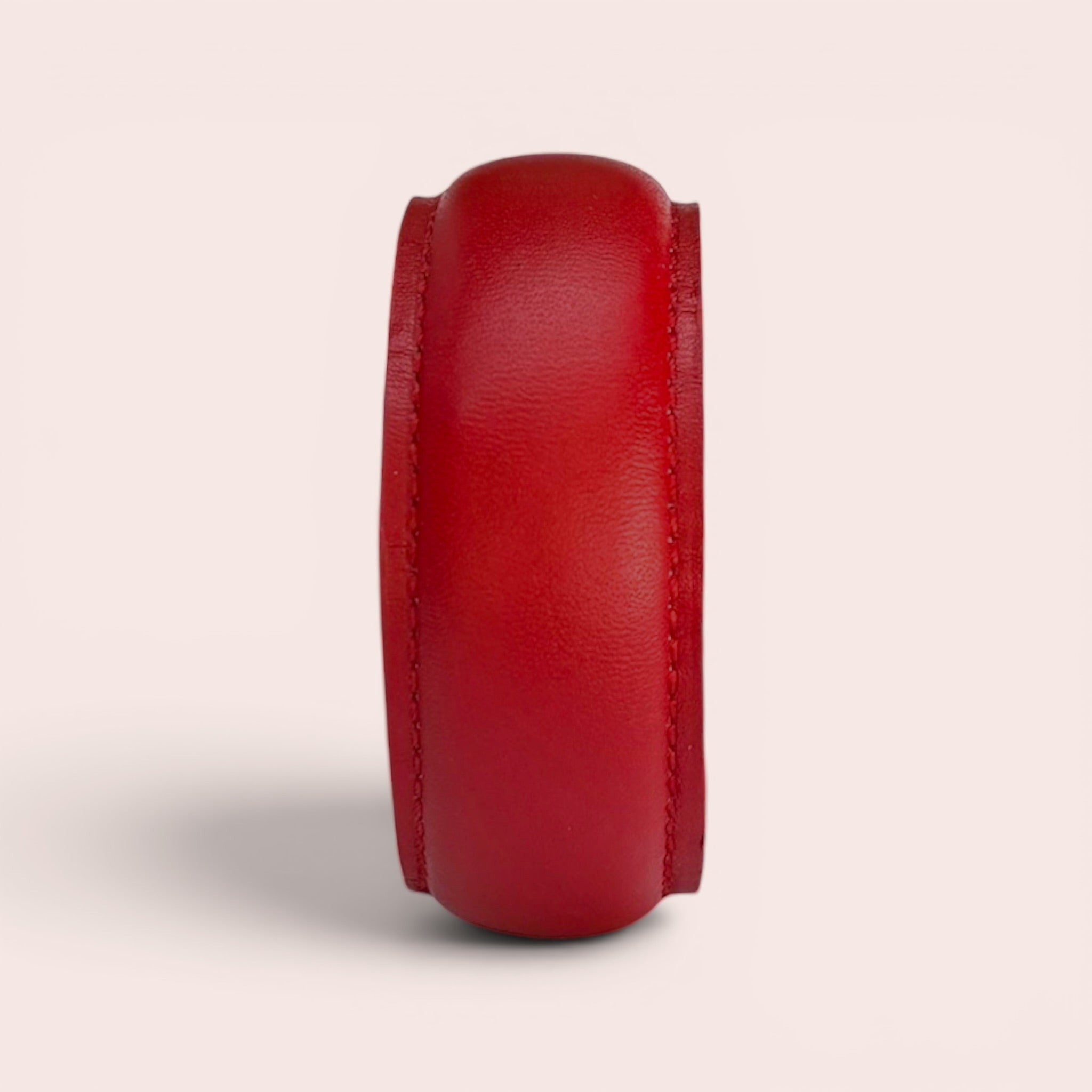 Wide red smooth leather bangle bracelet with stitched edges, minimalist luxury design