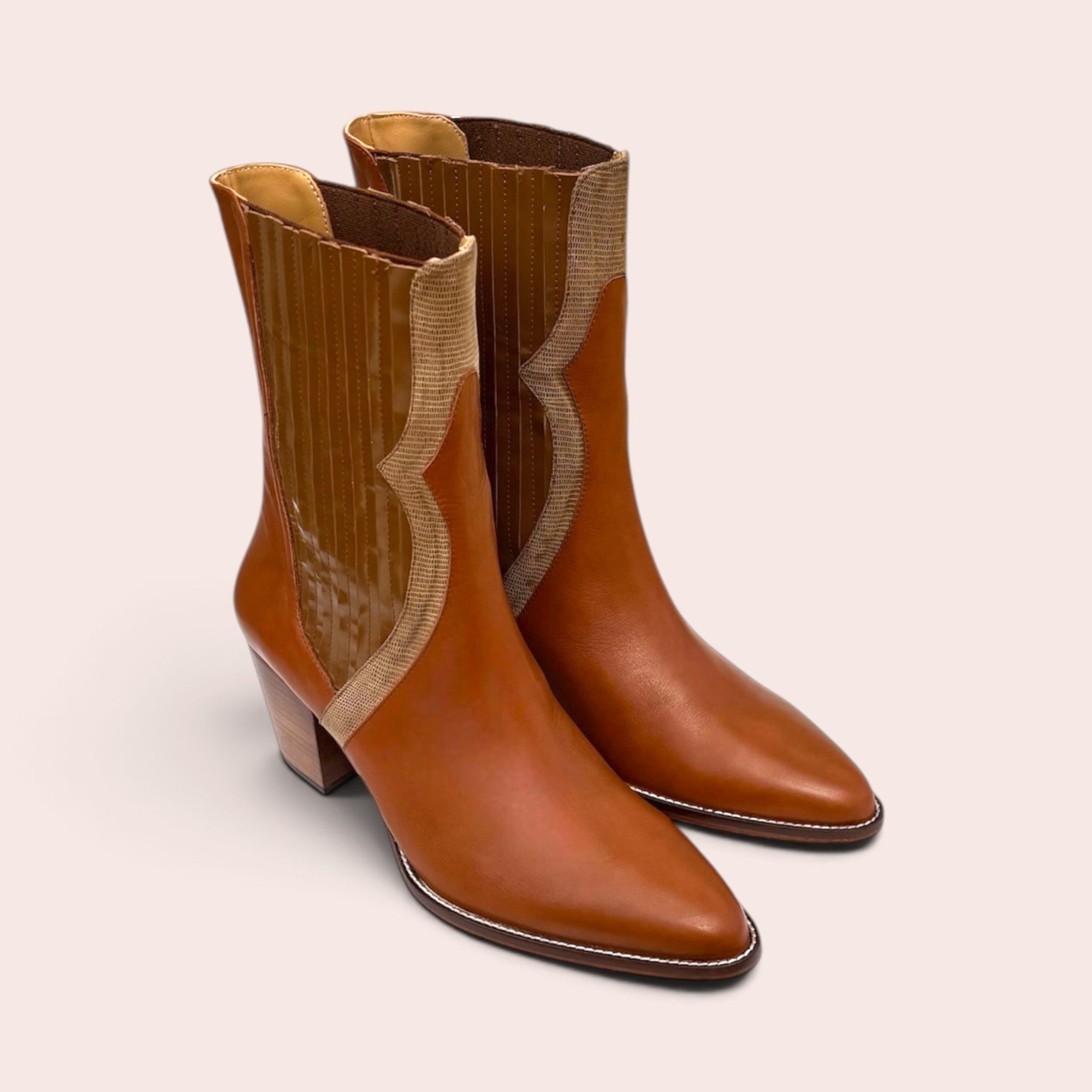 Tan leather mid-calf boots with a pointed toe, stacked block heel, and snake-embossed textured side paneling.