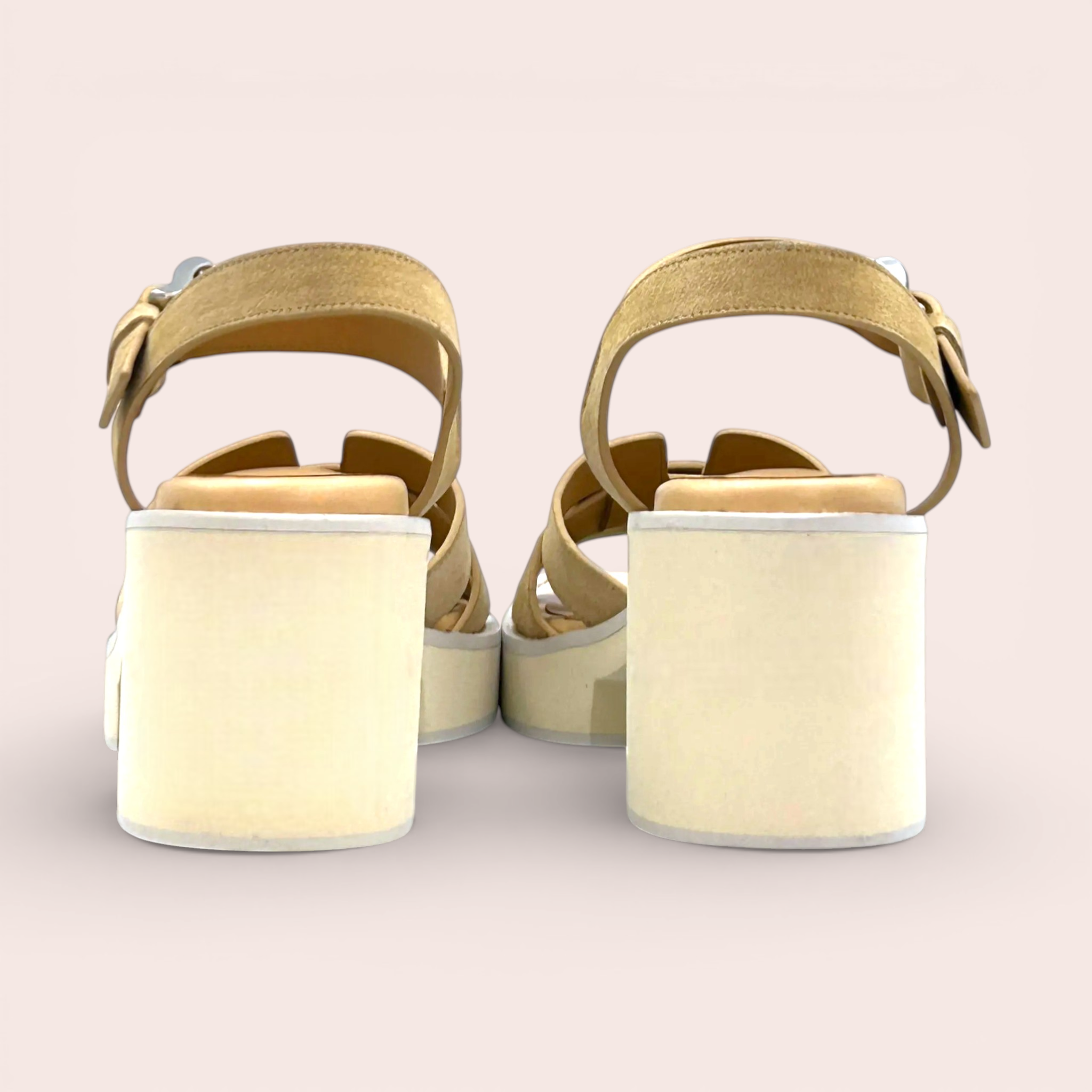 Tan suede platform sandals with criss-cross straps and a silver buckle detail. These sandals have a 65mm block heel and a sporty chic silhouette.