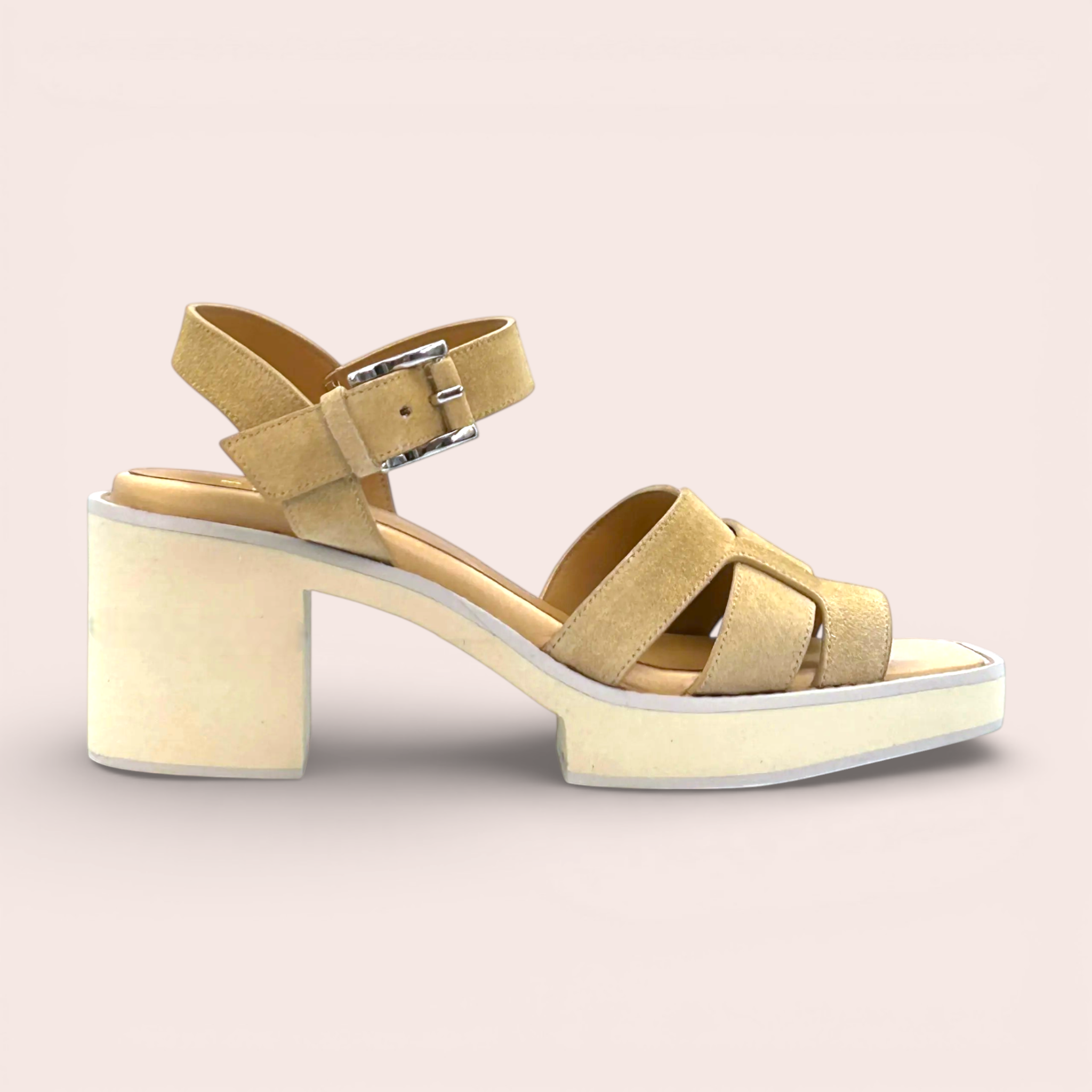 Tan suede platform sandals with criss-cross straps and a silver buckle ankle strap. These sandals have a 65mm block heel and a sporty chic silhouette.
