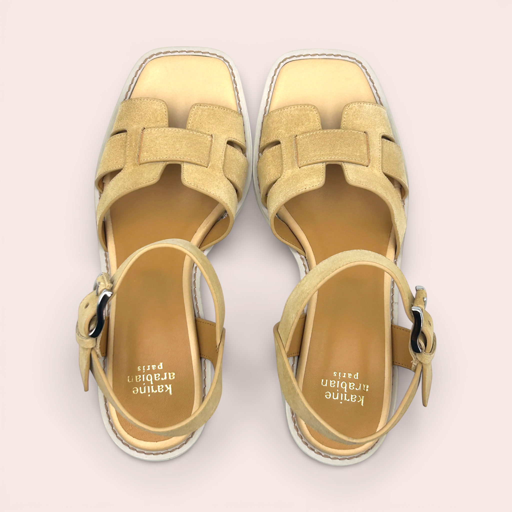 Light tan suede leather sandals with interlocking straps and an adjustable ankle strap. These platform sandals have a square toe and a subtle platform sole.