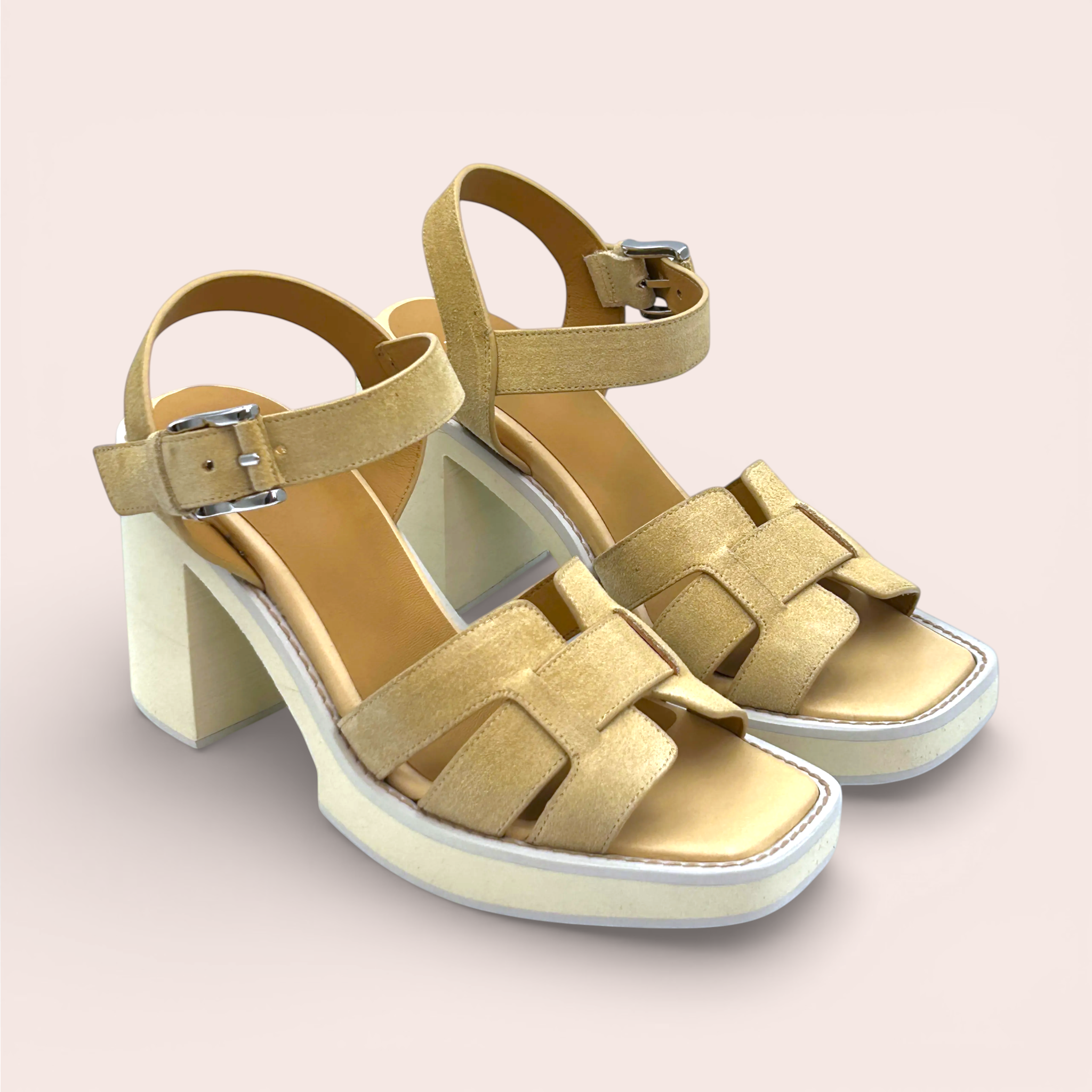 Tan suede platform sandals with interlocking straps and an adjustable ankle strap with a silver buckle. These sandals have a chunky block heel and a square toe.