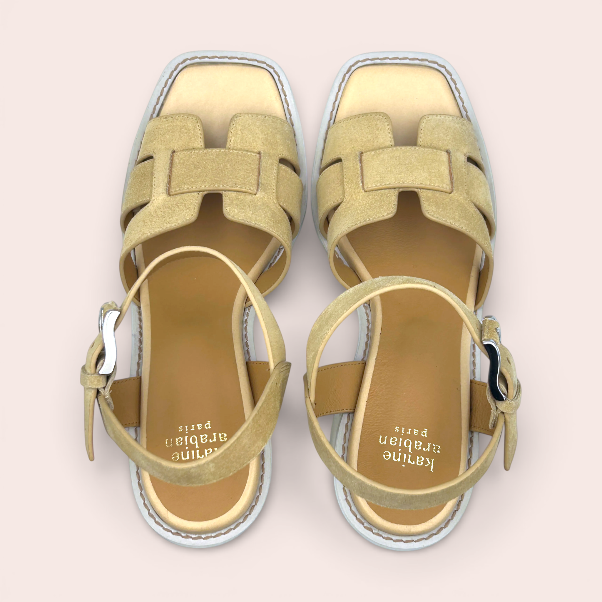 Tan suede leather sandals with interwoven straps and a platform sole. Features an ankle strap with a silver buckle and a light tan leather footbed.