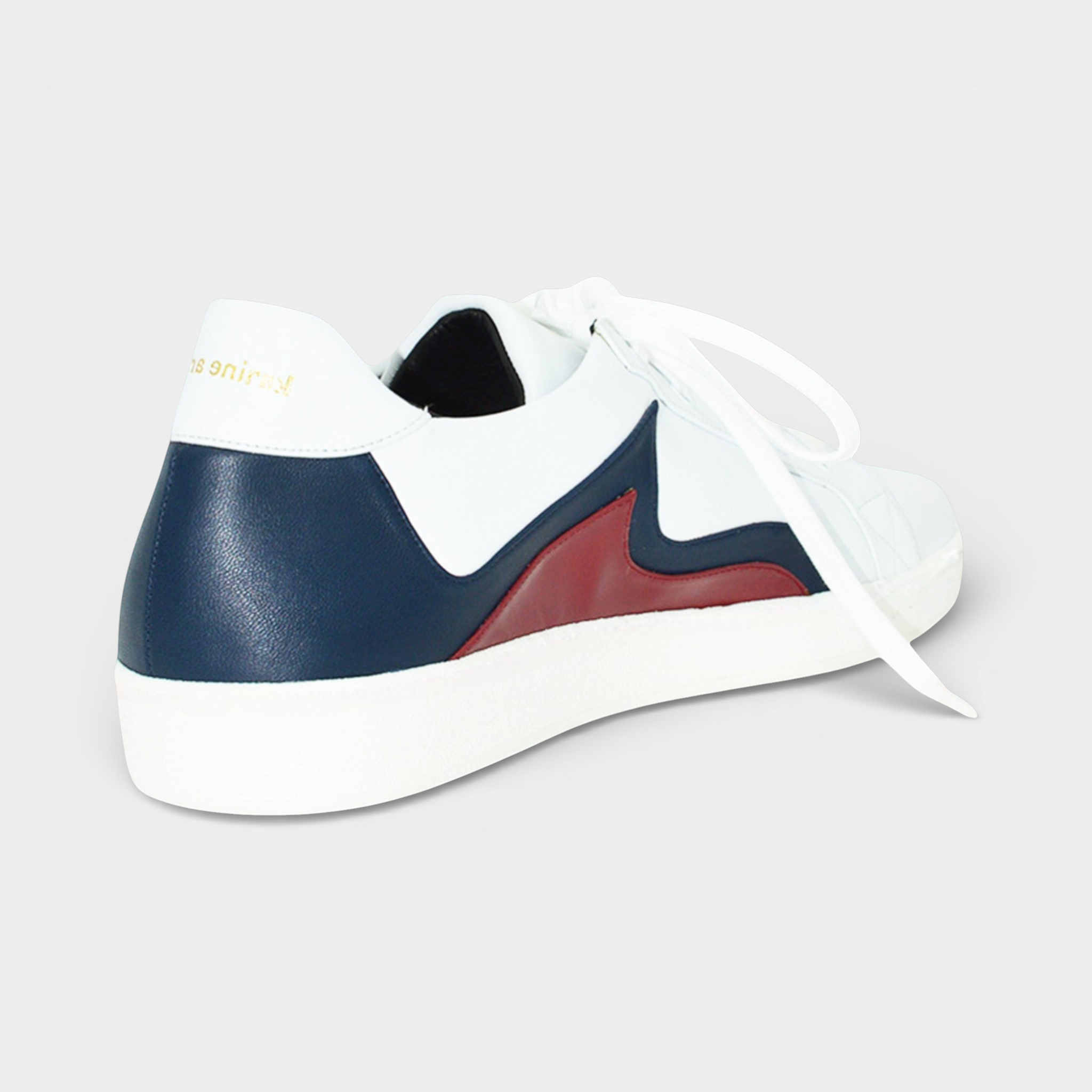 White leather low-top sneaker with navy blue and burgundy accents, white laces, and a white rubber sole.