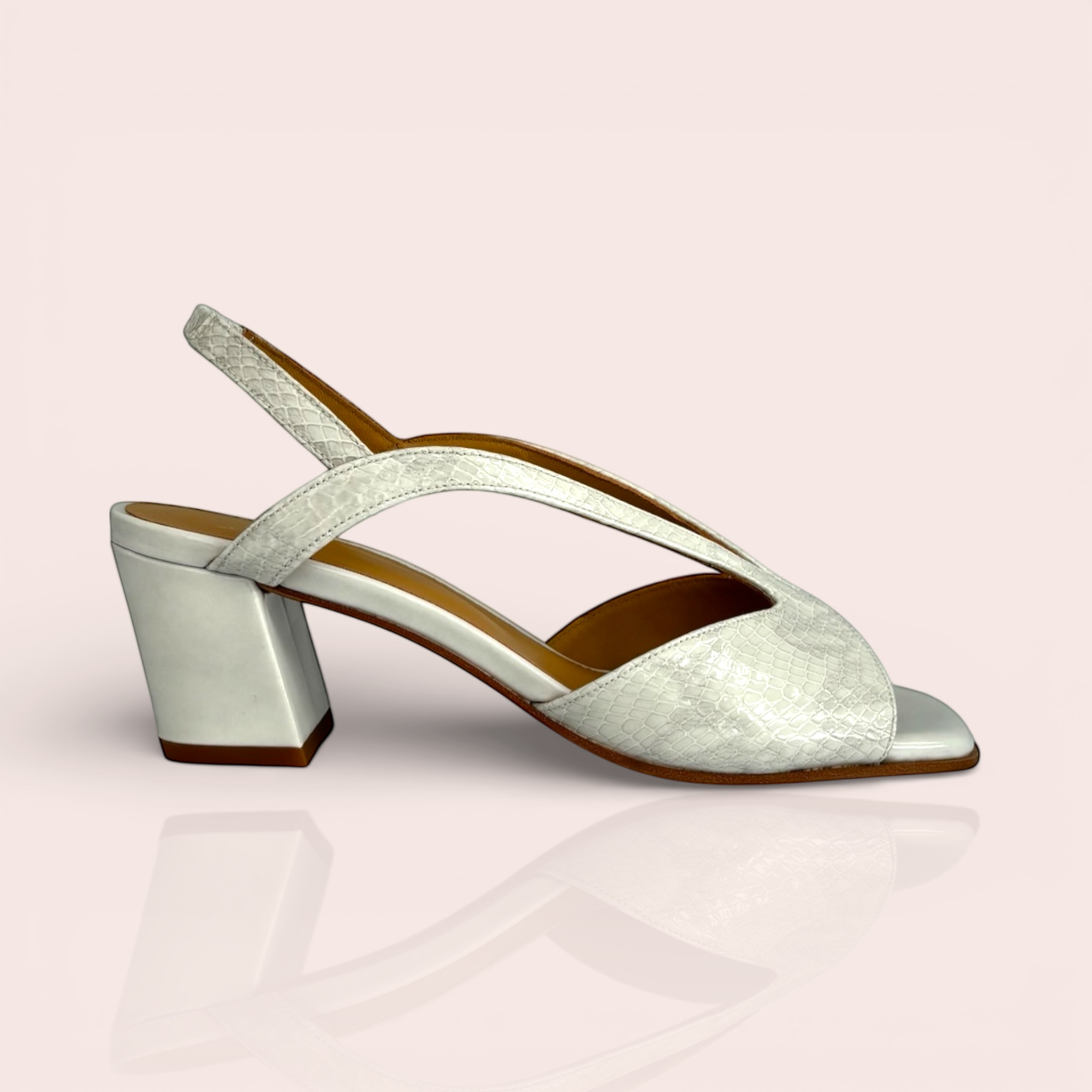 White leather slingback sandals with a snakeskin texture on the straps and a glossy finish on the block heel.